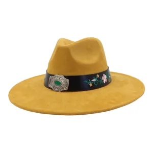 Detailed shot of the yellow suede fedora hat with black leather band and floral embroidery.