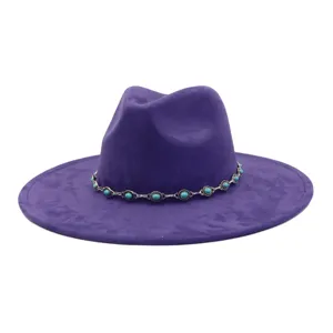 Close-up of a stylish purple faux suede fedora hat adorned with a silver turquoise chain.