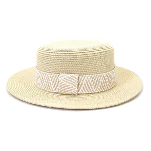 Closeup of stylish flat-top straw hat with woven band, perfect for summer sun protection.