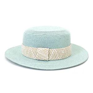 Detailed view of the mint green straw hat showing fine weaving and patterned ribbon band.