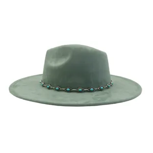 Detailed view of the sage green suede jazz hat featuring an exquisite turquoise chain.