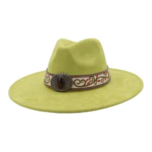 Detailed view of the green suede jazz hat featuring an ethnic embroidered band and vintage buckle.