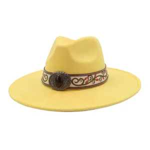 Yellow suede jazz hat detail, western wide brim style with vintage decorative band and buckle.