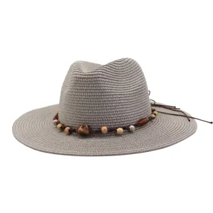 Summer straw beach hat with decorative bead band, stylish sun protection fedora cap detail.