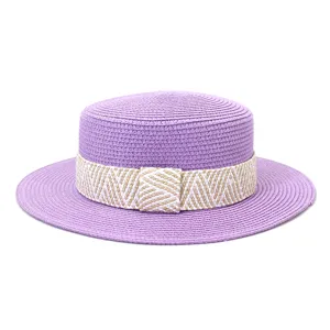 Detailed close-up view of a stylish purple straw boater hat with a chic woven band.