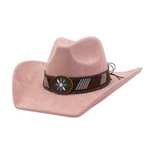 Closeup of pink suede western cowboy hat, featuring ethnic metal flower buckle and band.