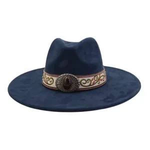 Close-up detail of the ethnic embroidered band and vintage gemstone buckle on the blue jazz hat.
