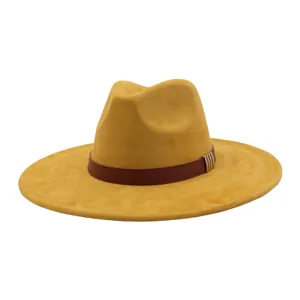 Detailed view of yellow suede fedora hat, featuring brown leather band and stylish metal buckle.