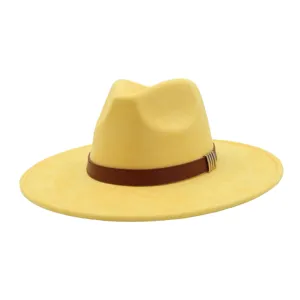 Yellow suede fedora hat featuring a brown leather strap and stylish metallic accent band.