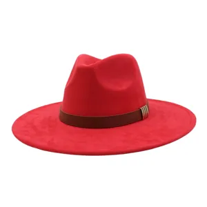 Close-up detail of a vibrant red suede fedora hat featuring a stylish brown leather belt and metal.