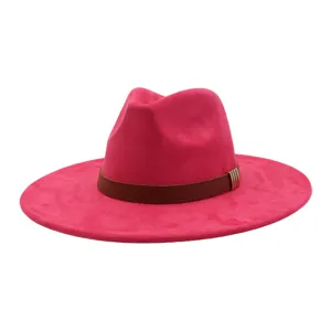 Detail shot of the pink suede fedora hat, featuring brown leather band and metal trim.