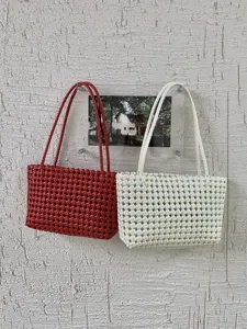 Red and white woven hollow beach tote bags detail view, stylish summer casual handbag.