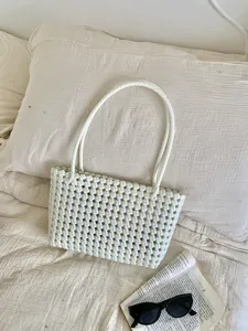 White woven hollow beach bag, casual summer tote handbag for daily commute and vacation.