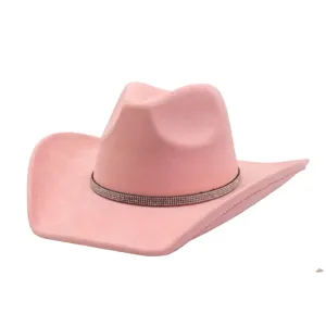 Pink suede cowboy hat detail showing the wide brim and sparkling rhinestone band design.