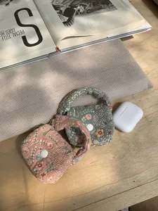 Charming embroidered mini earphone pouch soft coin purse with cute handle and snap closure detail.