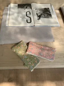Detailed shot of floral embroidered glasses case, portable zipper pouch for sunglasses.