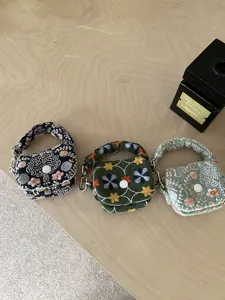 Mini vintage floral embroidered Bluetooth earphone pouch coin purse with metal clasp.