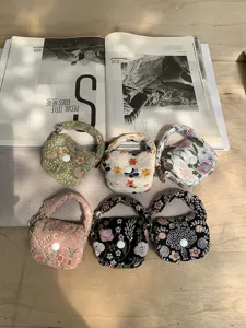 Mini floral embroidered pouch bag for bluetooth earphones, cute hanging coin purse charm details.