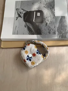 Mini embroidered floral pouch portable headphone storage bag and coin purse pendant.
