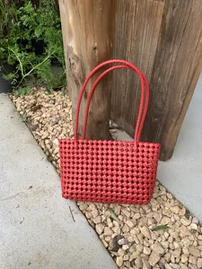 Red woven plastic tote bag detail view, perfect for summer beach and daily casual use.