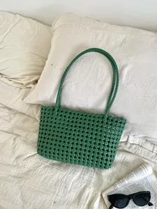 Green woven beach tote bag detail view, stylish hollow design for summer vacation daily commuting.