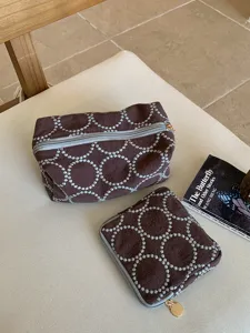 Brown fabric cosmetic bag set with embroidered circle pattern, retro design storage pouch.