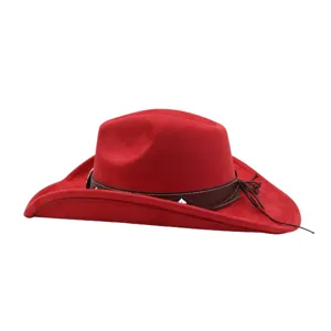 Red suede cowboy hat close up showing soft texture and brown leather band with tassel.