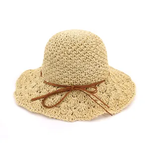 Detailed view of the women summer crochet straw hat with wide brim and cute bow tie ribbon.