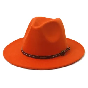 Orange wool fedora hat detail, wide flat brim, brown leather strap with metal buckle.