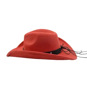 Close-up detail of the red suede cowboy hat featuring a black strap and side cords.