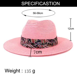 Pink straw fedora sun hat for summer outdoor travel with colorful patterned band and specs.