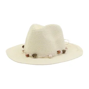 Beige woven straw hat detail showcasing decorative beaded rope band and texture craftsmanship.