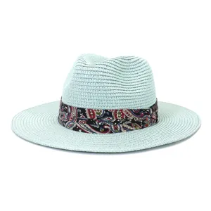 Mint green straw fedora hat with vibrant paisley print ribbon band for summer outdoor travel.