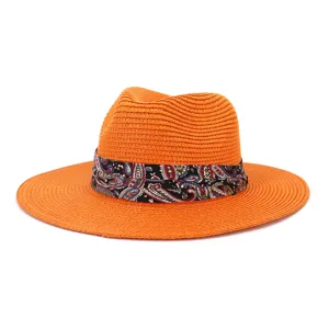 Orange straw fedora hat for summer beach travel outdoor sun protection with paisley ribbon.