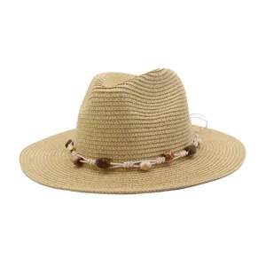 Detail view of a stylish straw fedora hat featuring beaded rope decor for summer outdoor sun protection.