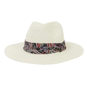 Close-up of a stylish summer straw fedora hat featuring a colorful paisley band detail.