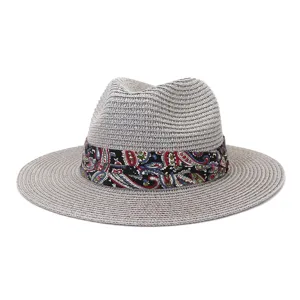Detailed view of the stylish summer straw fedora hat with colorful paisley band for outdoor sun.