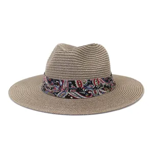 Detailed view of summer straw fedora hat featuring colorful paisley ribbon band for sun protection.