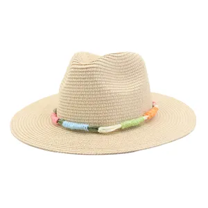 Detailed view of summer straw fedora hat, classic wide brim with colorful braided band.
