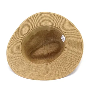 Close-up detail view of the straw fedora hat interior structure and washing label.