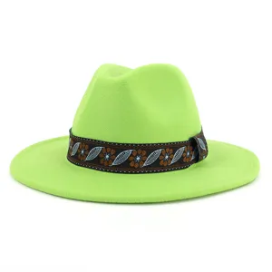 Close up detail view of the green felt jazz hat, highlighting the ethnic ribbon and flat brim.