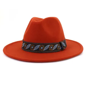 Close-up detail of orange fedora hat with ethnic patterned ribbon, fine woolen texture.