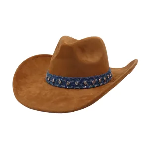 Close-up of the textured brown suede surface and the sparkling rhinestone denim decorative band.