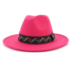 Detailed close-up view of a vibrant hot pink felt fedora hat with an ethnic woven band.