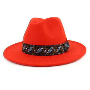 Detailed view of a stylish red wool fedora hat featuring an exquisite ethnic pattern band.