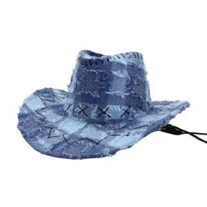 Detail view of the distressed blue denim patchwork cowboy hat showing raw frayed edges and stitching.