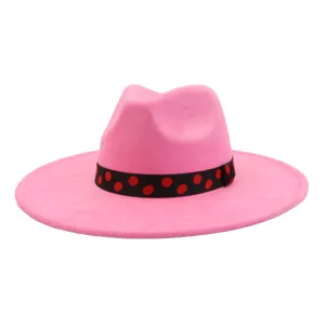 Gros plan chapeau feutre rose, bord plat, ruban pois, belle texture et finition soignée.