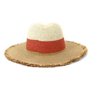 Close-up detail of the woven straw fedora hat featuring color-blocked design and frayed brim.
