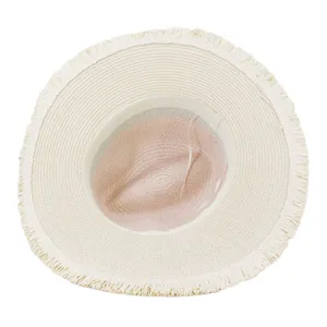 Detailed view of the wide brim straw hat with fringe edge and two tone design for summer.