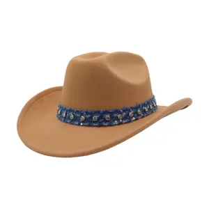 Close up view of stylish brown felt cowboy hat with blue rhinestone denim band detail.